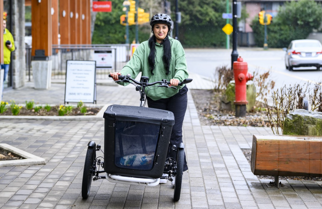 Woman riding a cargo bike.