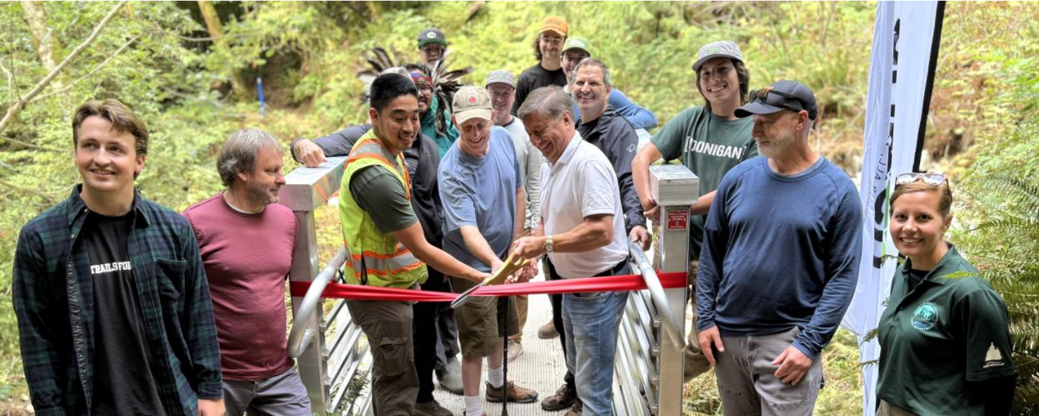 Community members and partners cut a red ribbon at the opening of the East Cypress Climb Trail in West Vancouver on September 10, 2025.